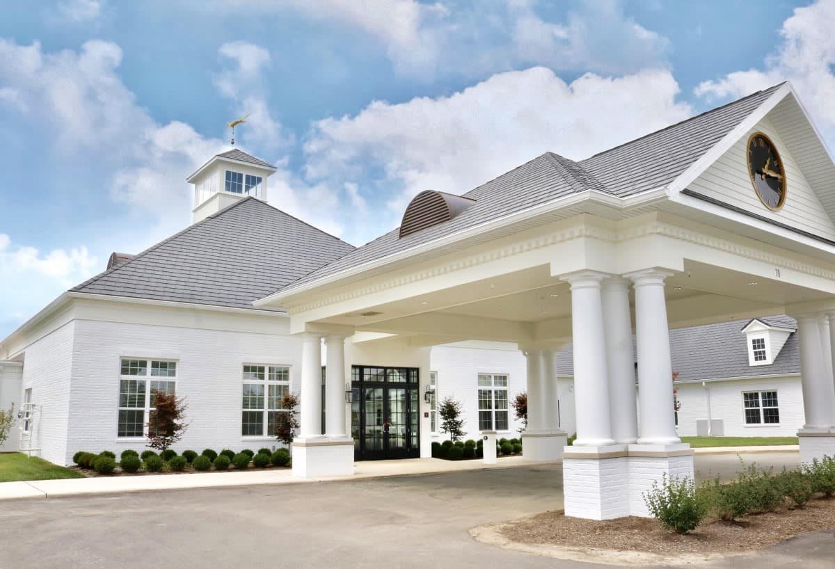 A modern white building with a grand entrance supported by columns.