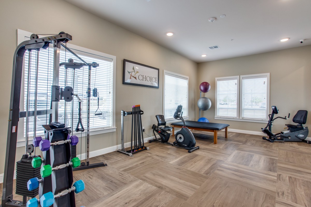 A well-equipped home gym with various fitness machines and exercise tools.