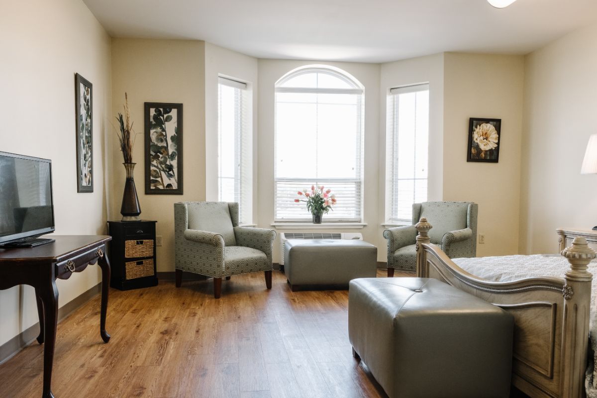 A cozy living room with stylish furniture and large windows allowing natural light to fill the space.