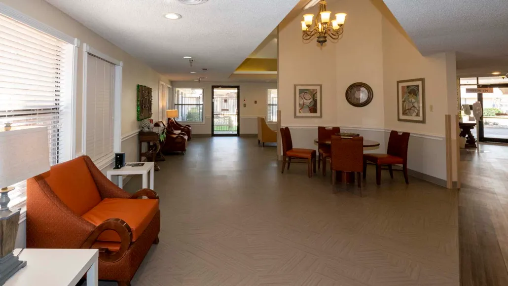 Spacious living area with comfortable seating and a chandelier.