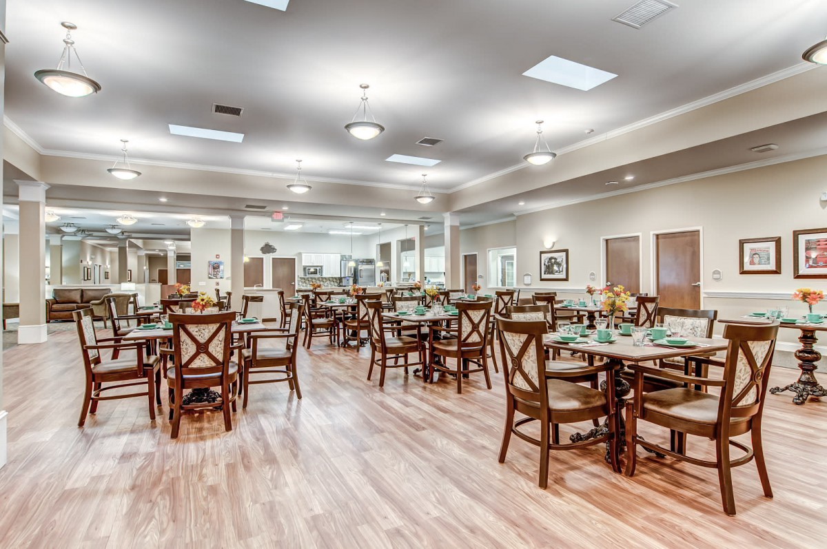 A spacious dining area with neatly arranged tables and chairs.