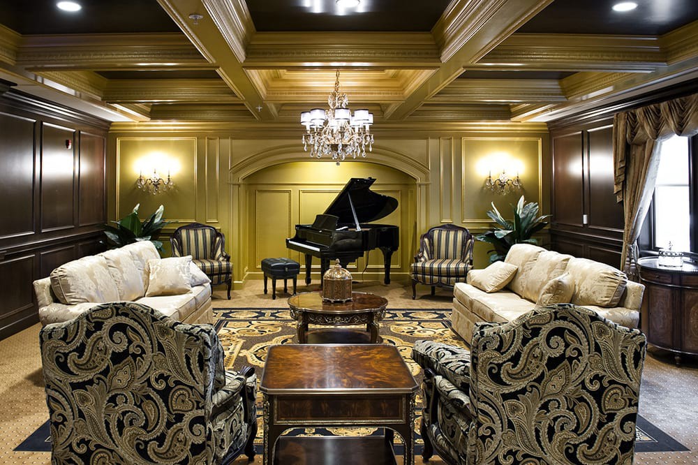 A luxurious living room featuring a grand piano and elegant furnishings.