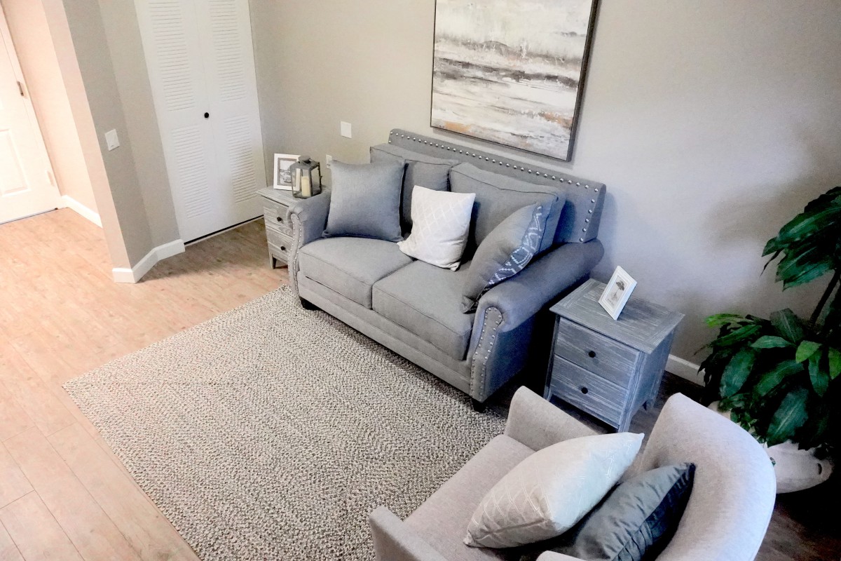 A cozy living room with a gray sofa and stylish decor.