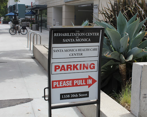 A sign indicating the location of a rehabilitation center in Santa Monica, with instructions for parking.