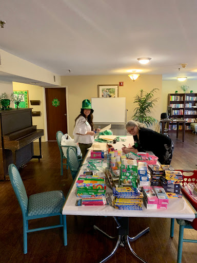 Volunteers organizing craft supplies at a community center.