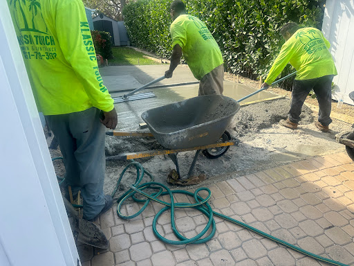 Workers preparing concrete for outdoor construction.