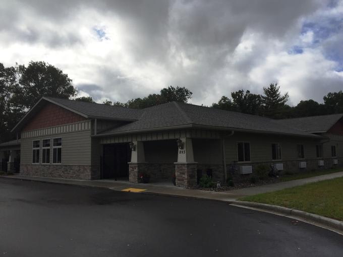 A residential building under a cloudy sky.
