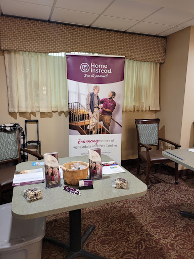A display area featuring a banner and informational materials for home service offerings in a conference room setting.