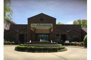 A brick building with a sign labeled 'The Altenheim' over the entrance.