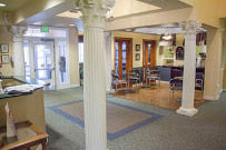 A library lobby with seating and a decorative column.