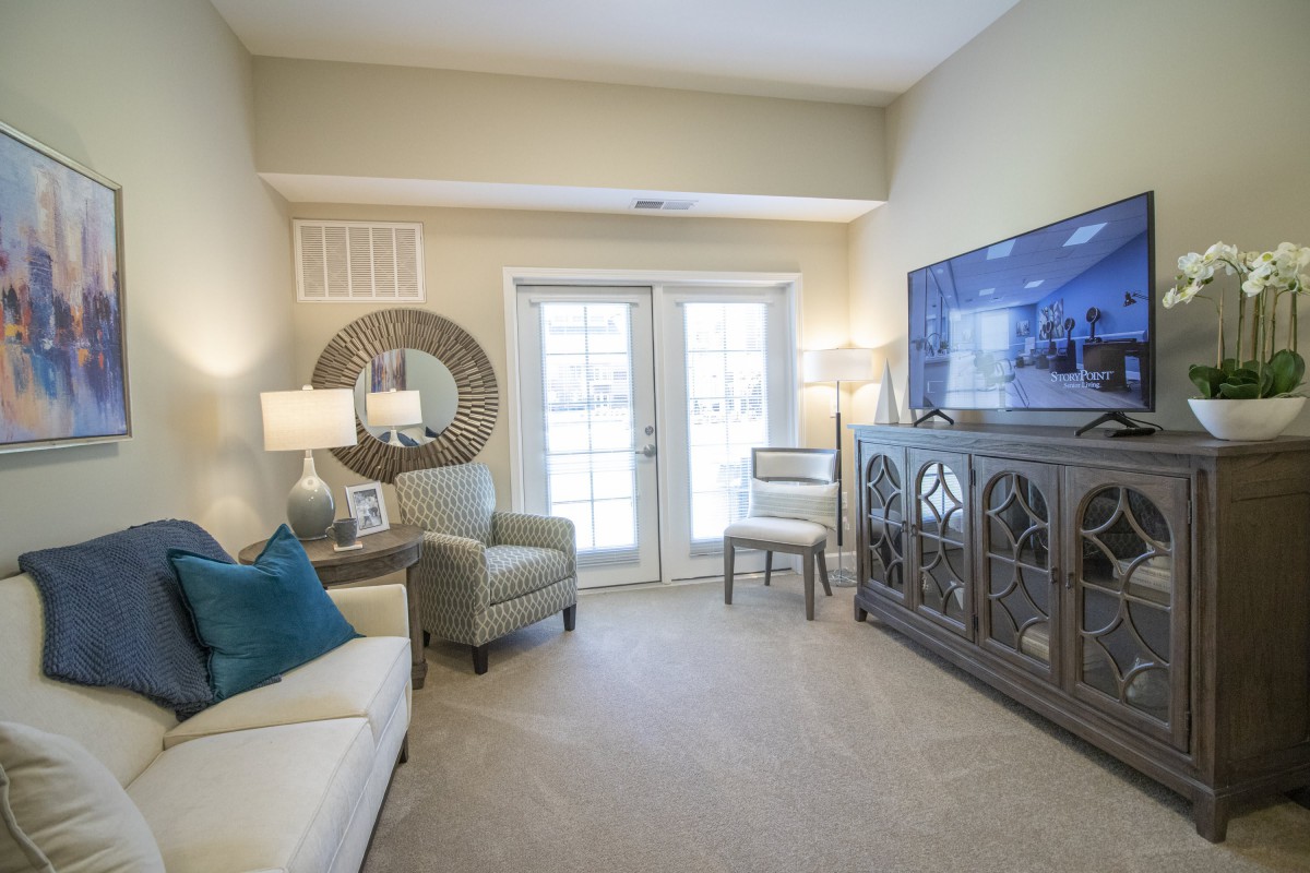 A cozy living room with comfortable seating, stylish decor, and a television for entertainment.