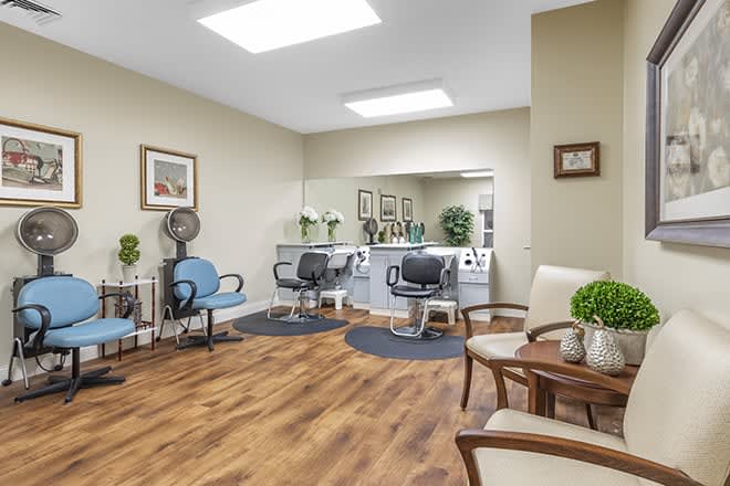 A cozy hair salon with styling chairs, mirrors, and a waiting area.