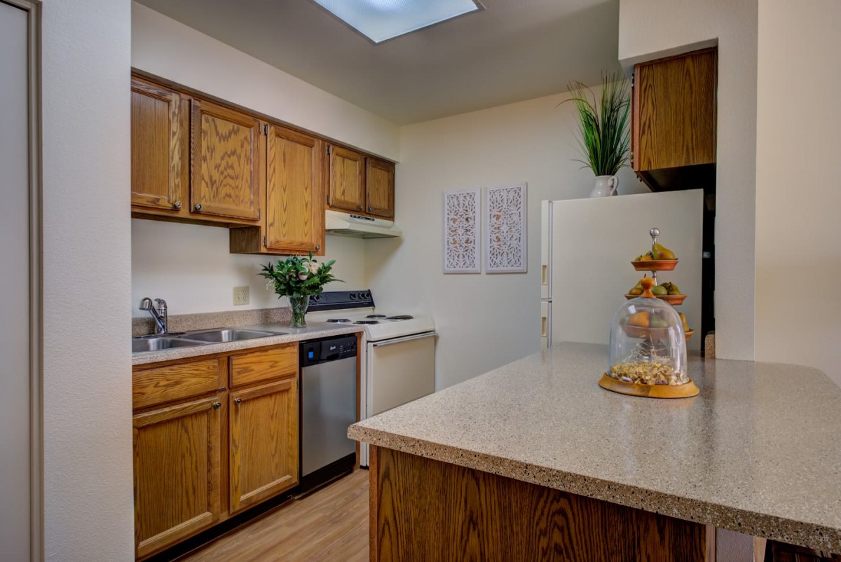 A cozy kitchen interior with wooden cabinets and modern appliances.