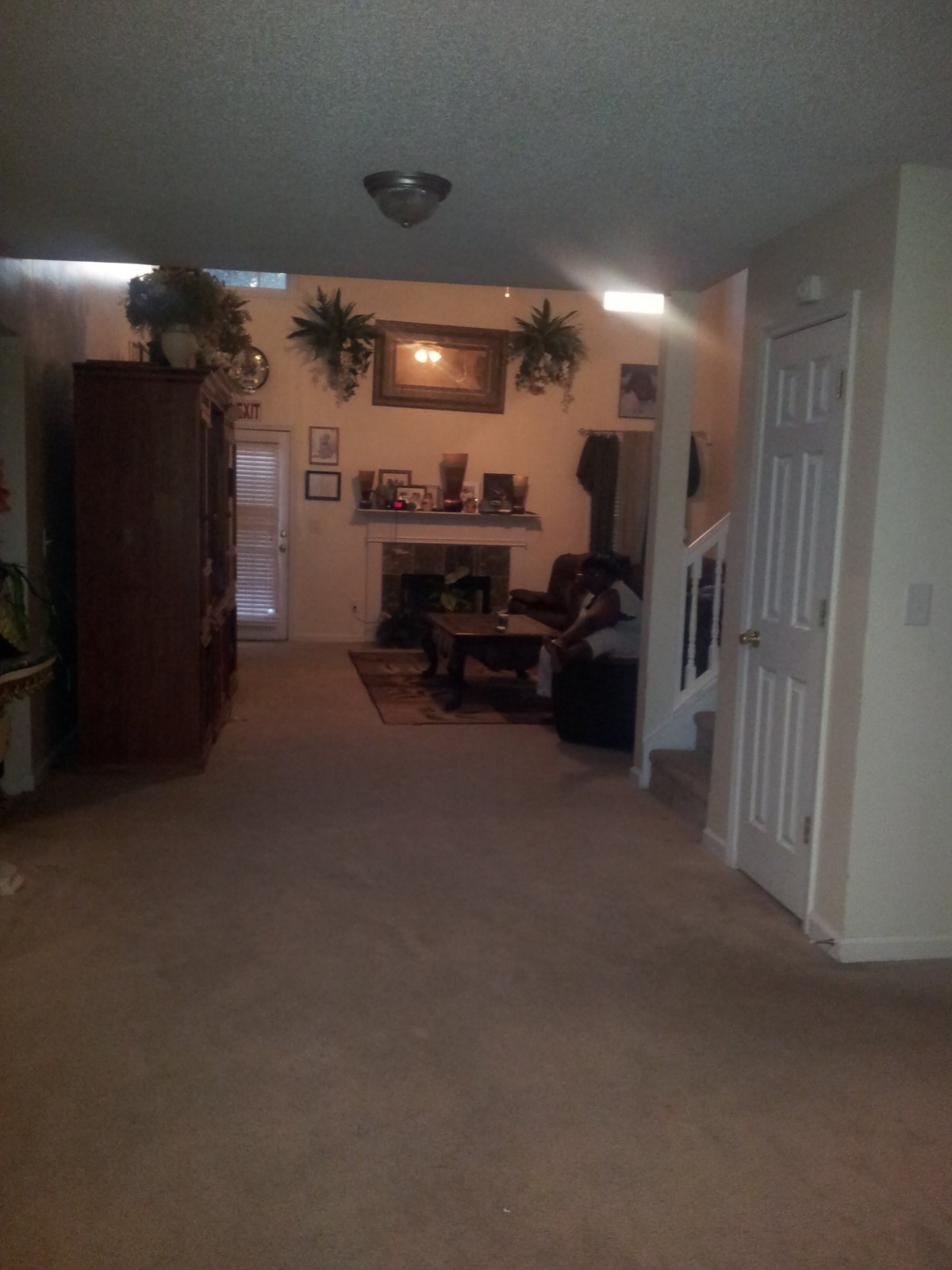 A cozy living room with a fireplace and various decorations.