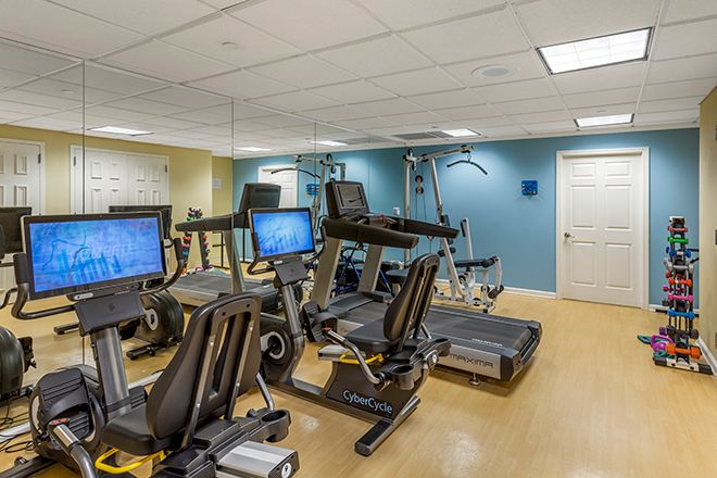 A well-equipped indoor gym with treadmills and stationary bikes.