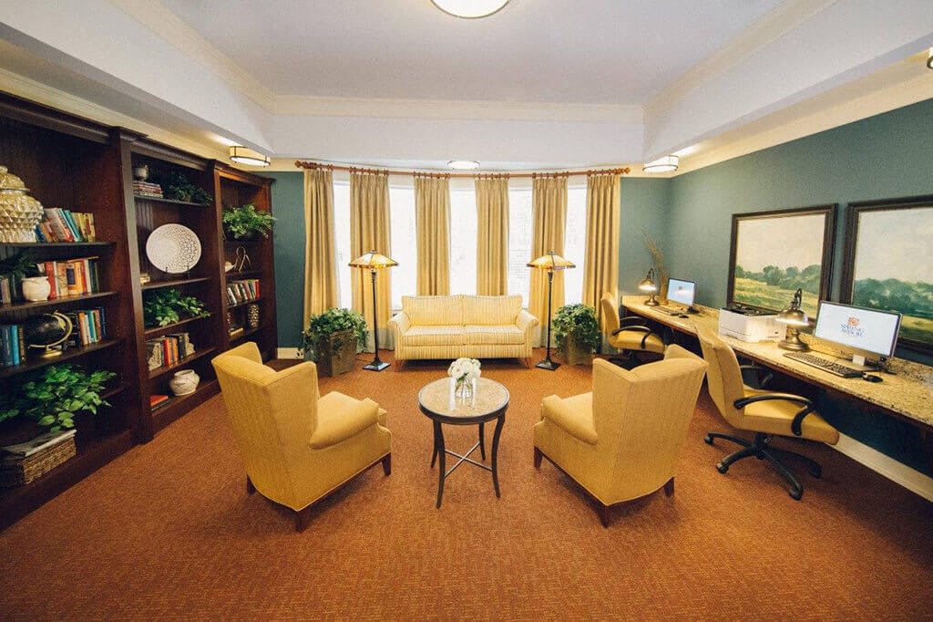 A cozy living room with yellow seating and warm decor.