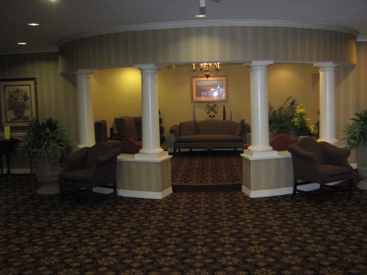 A cozy hotel lobby featuring elegant columns and comfortable seating.