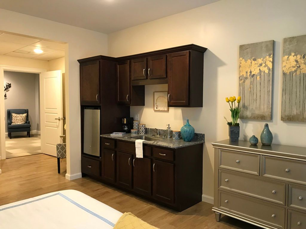 A cozy kitchenette with dark cabinets and modern decor in a home setting.