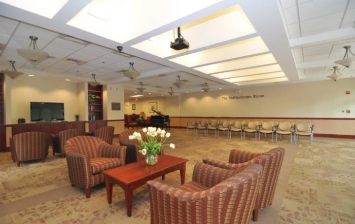 A modern waiting room with comfortable seating and ambient lighting.
