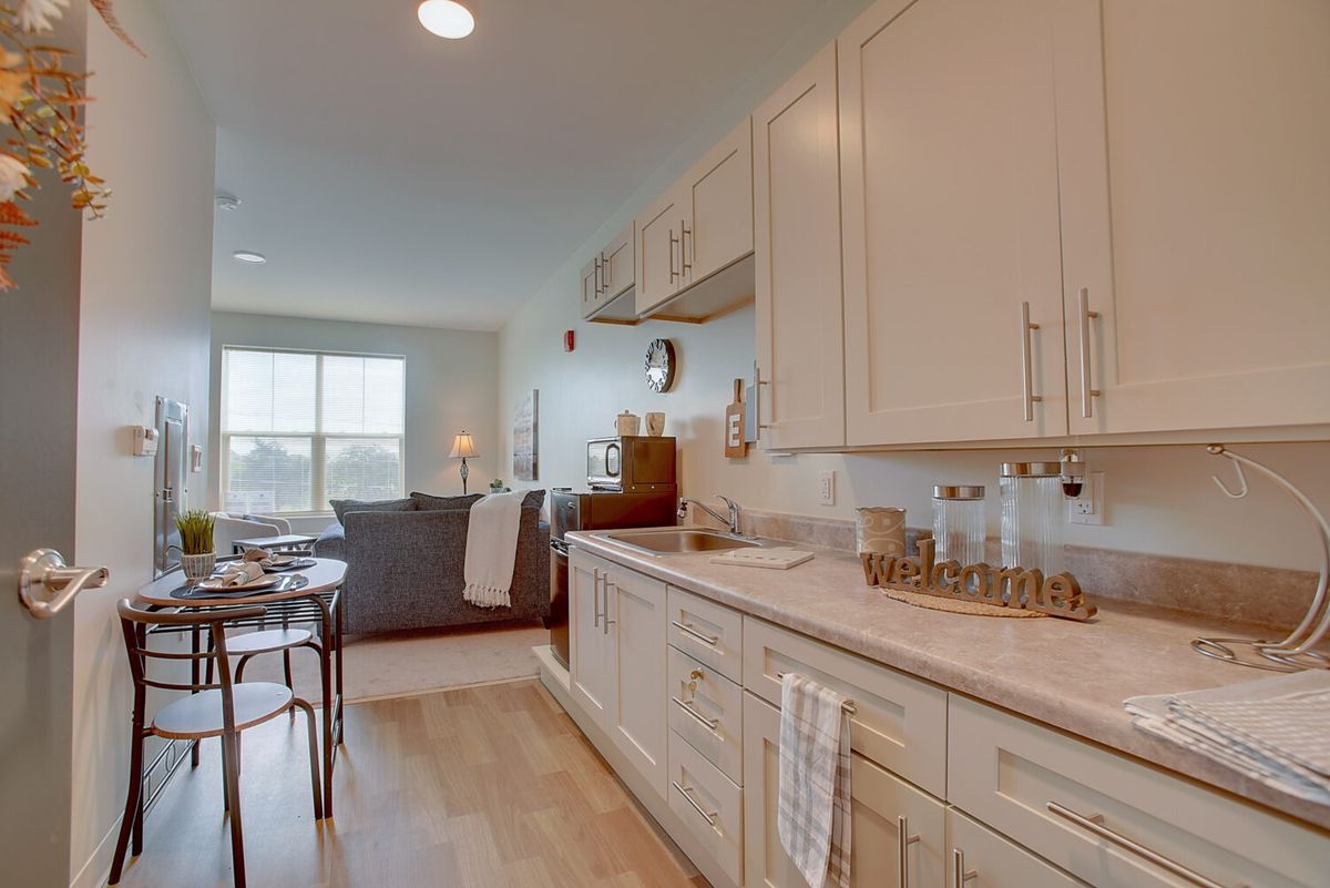 A modern open-plan kitchen and living area with natural lighting.