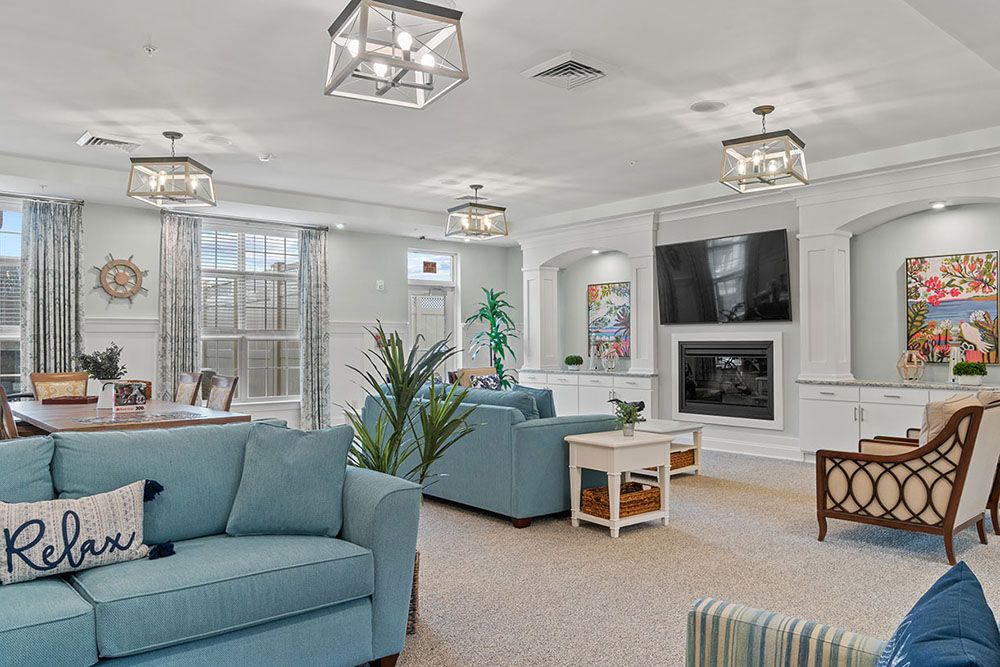 A spacious and modern living room with stylish furniture and elegant lighting.