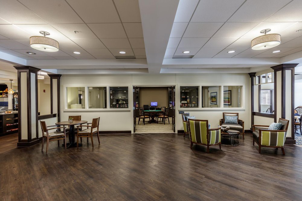 A modern lobby with comfortable seating and wooden flooring.