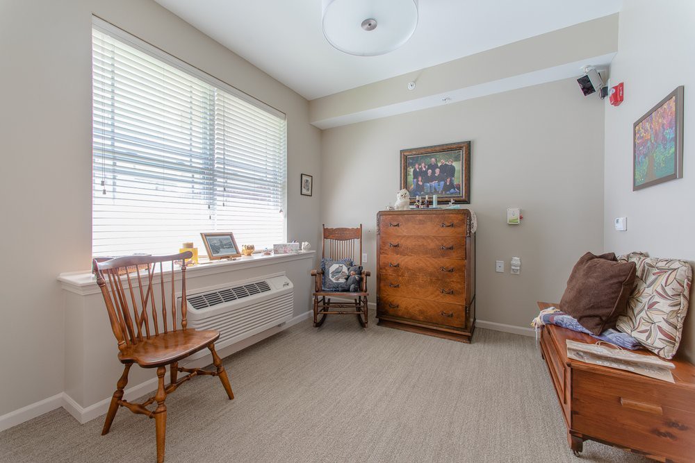 A cozy room with wooden furniture and ample natural light.