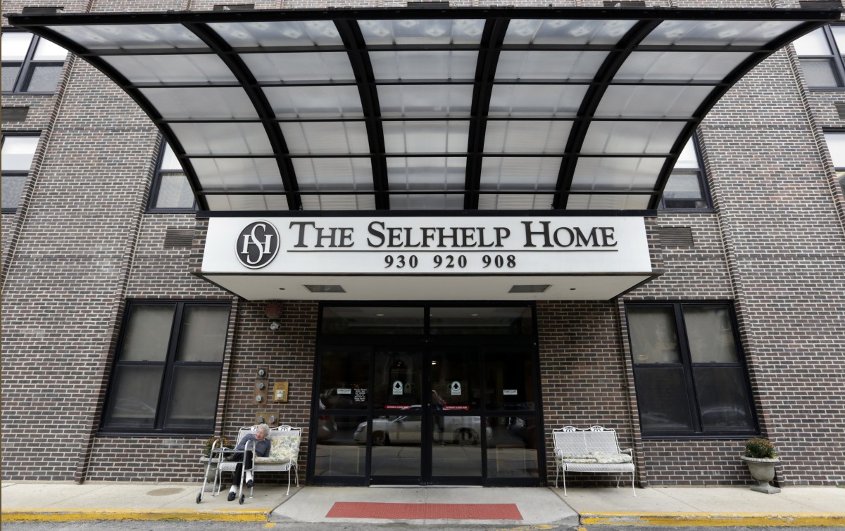 The entrance of The Selfhelp Home, featuring a clear awning and seating.