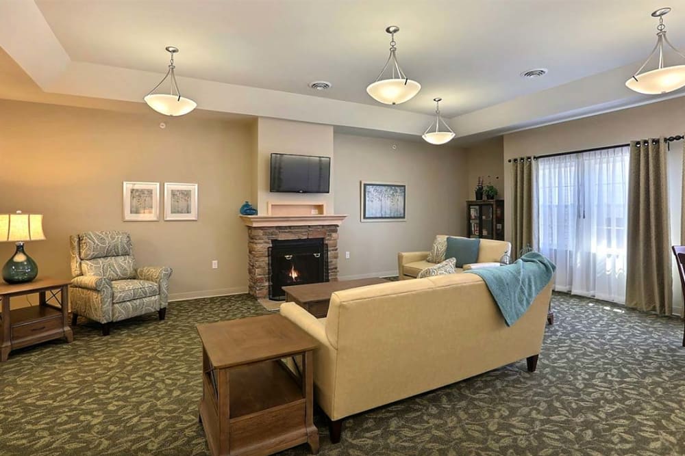 A cozy living room with a sofa, a coffee table, and a fireplace.