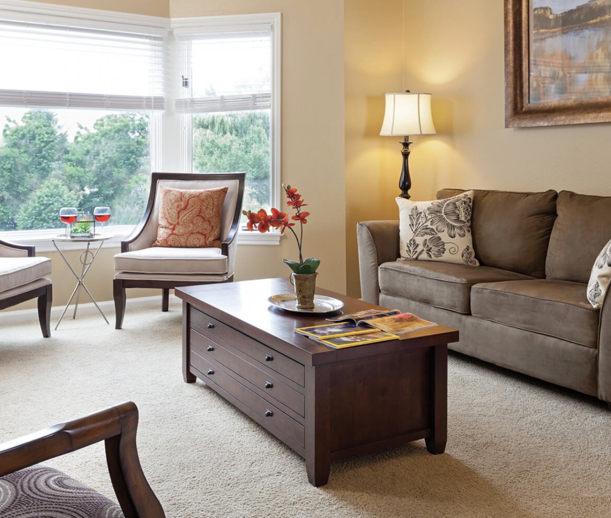 A cozy living room with a sofa, coffee table, and elegant decor.