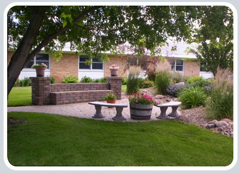 A tranquil garden with benches and lush greenery.