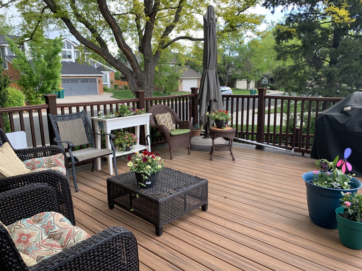 A cozy patio with comfortable seating and potted plants.