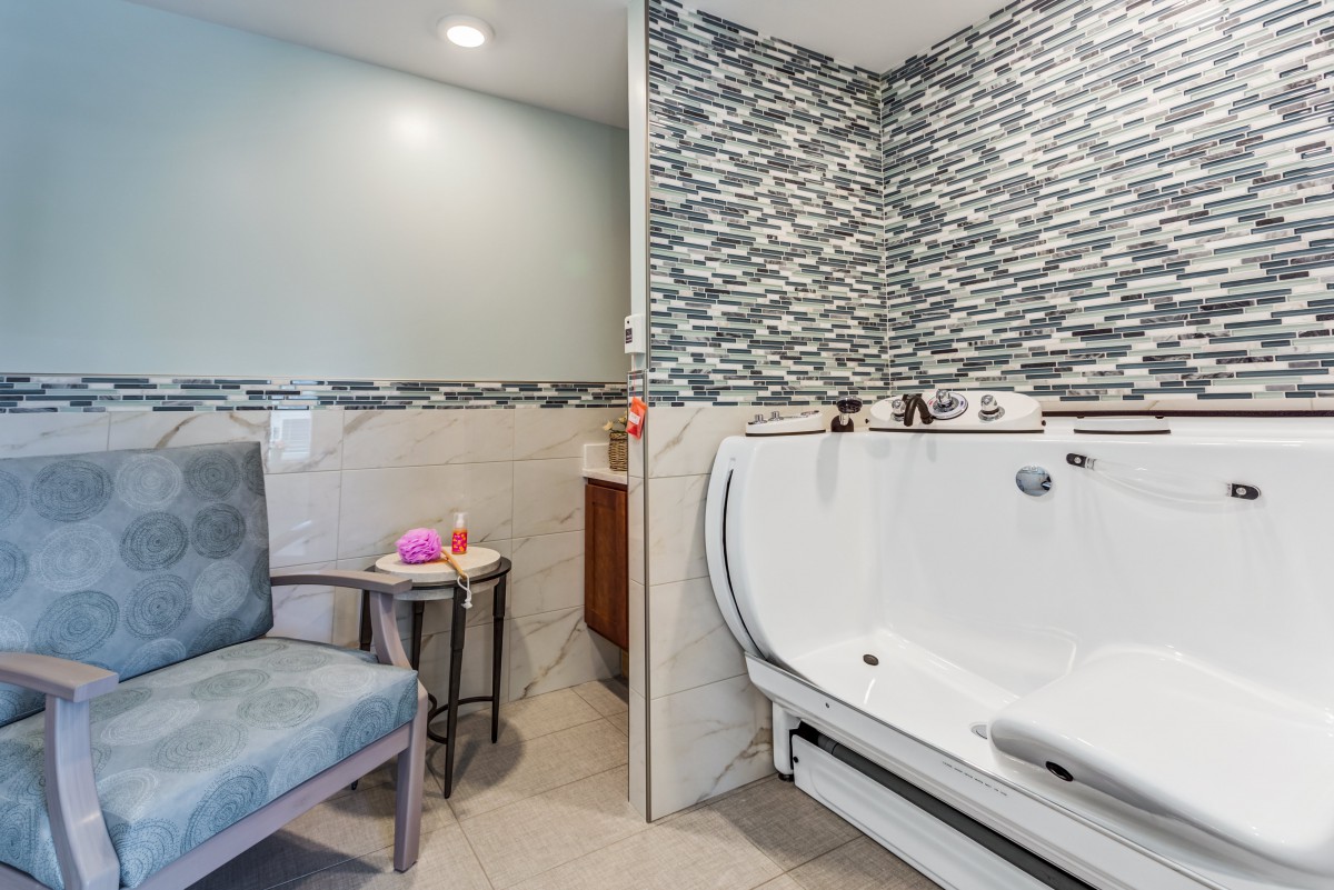 A modern bathroom featuring a walk-in tub and stylish tile accents.