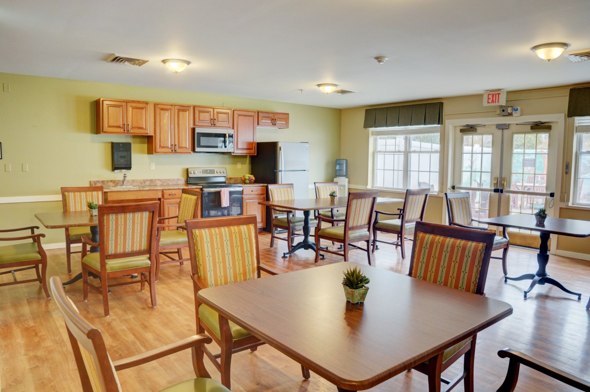 A spacious kitchen and dining area with wooden furniture and bright lighting.