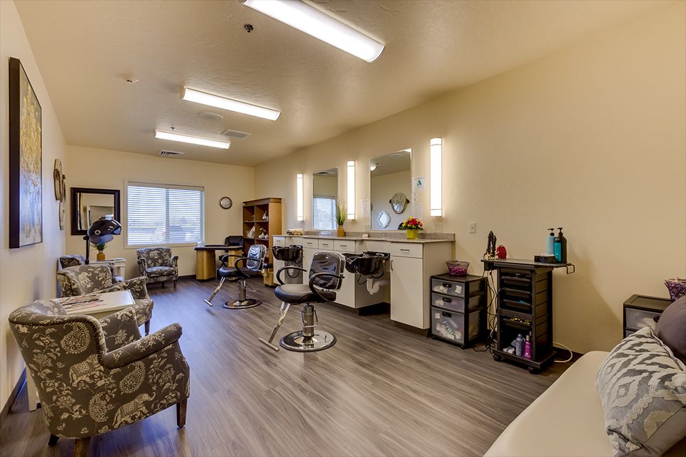 A modern hair salon interior with styling chairs, mirrors, and various equipment.
