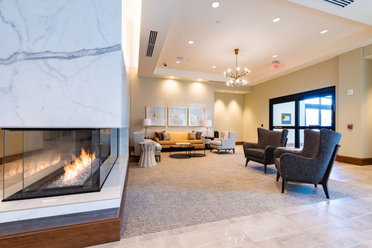 A modern lobby with a cozy fireplace and comfortable seating.