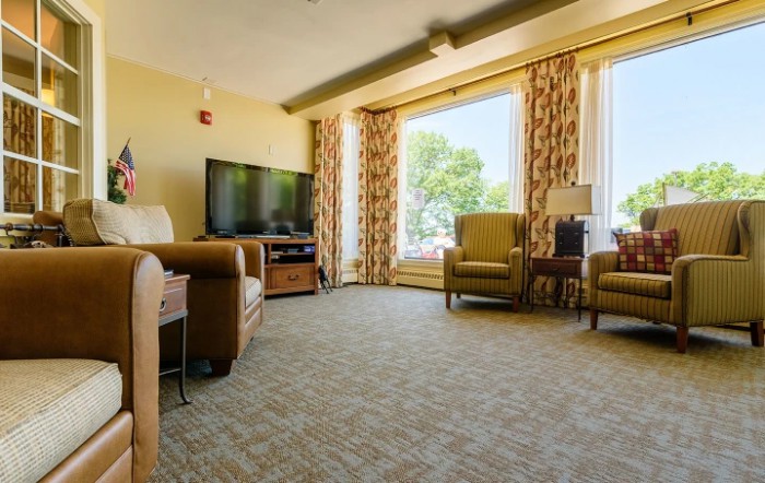 A cozy living room with comfortable seating and a large window.