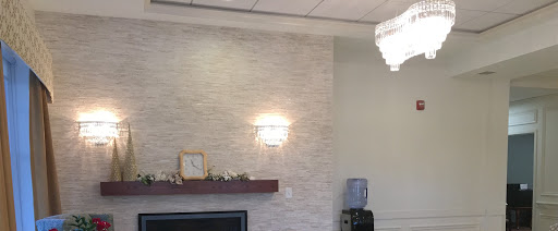 A modern living space featuring a textured wall, stylish lighting, and minimalist decor.