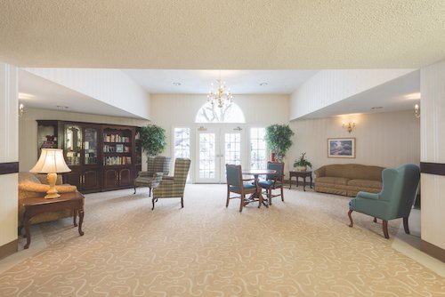 A spacious living room with elegant furniture and natural lighting.