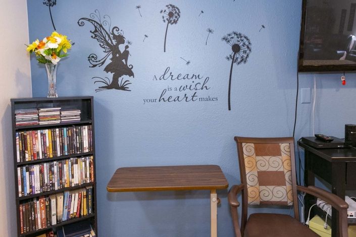 A cozy reading corner with wall art and inspirational quotes.