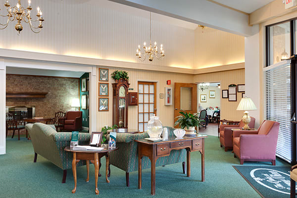 A cozy lobby area with comfortable seating, decorative accents, and a chandelier.