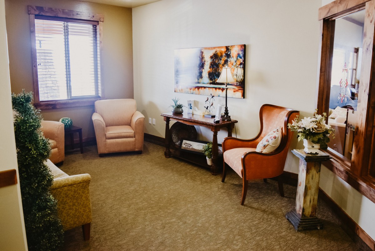 A cozy living room with a mix of comfortable chairs and elegant decor.