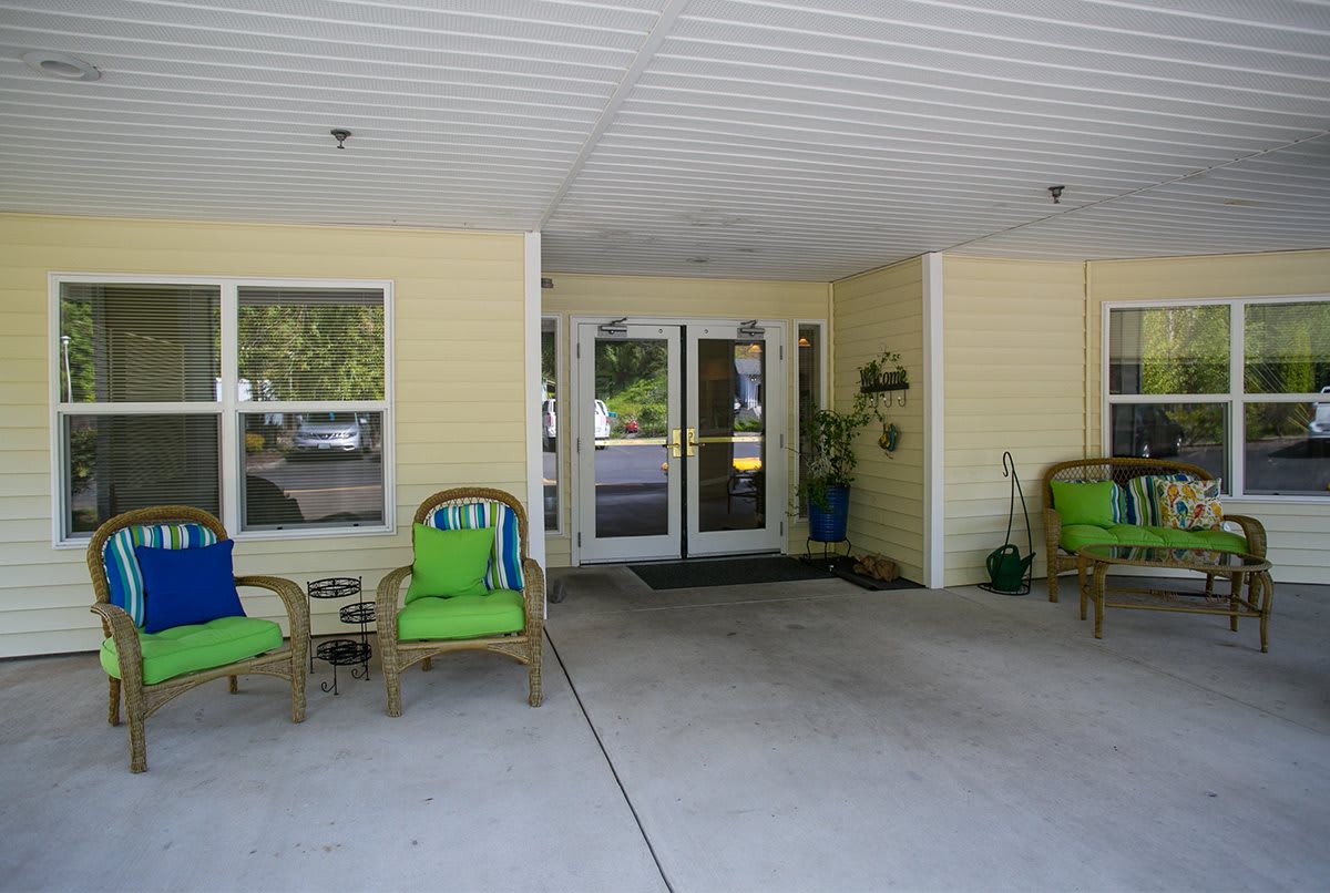A covered entrance area with seating and decorations.