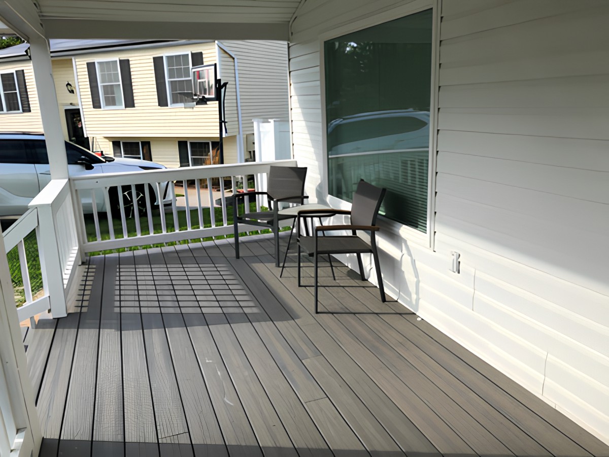 A cozy porch with chairs and a table in a suburban residential setting.