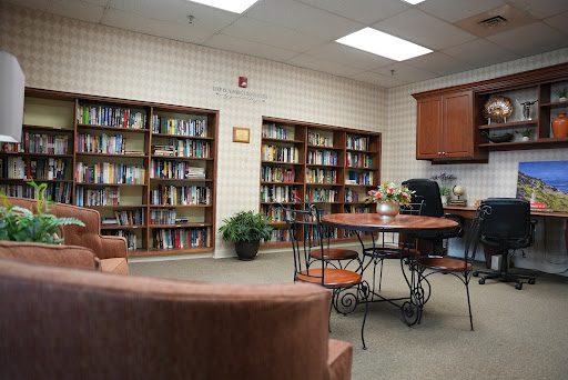 A cozy reading area with bookshelves full of books and a small table for study or relaxation.