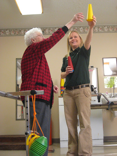 A caregiver and an elderly individual engage in a joyful interaction, highlighting meaningful support and companionship.