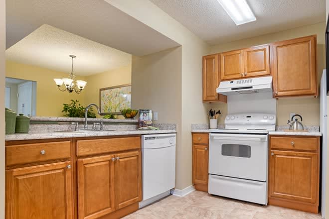 A cozy kitchen with wooden cabinets and modern appliances.