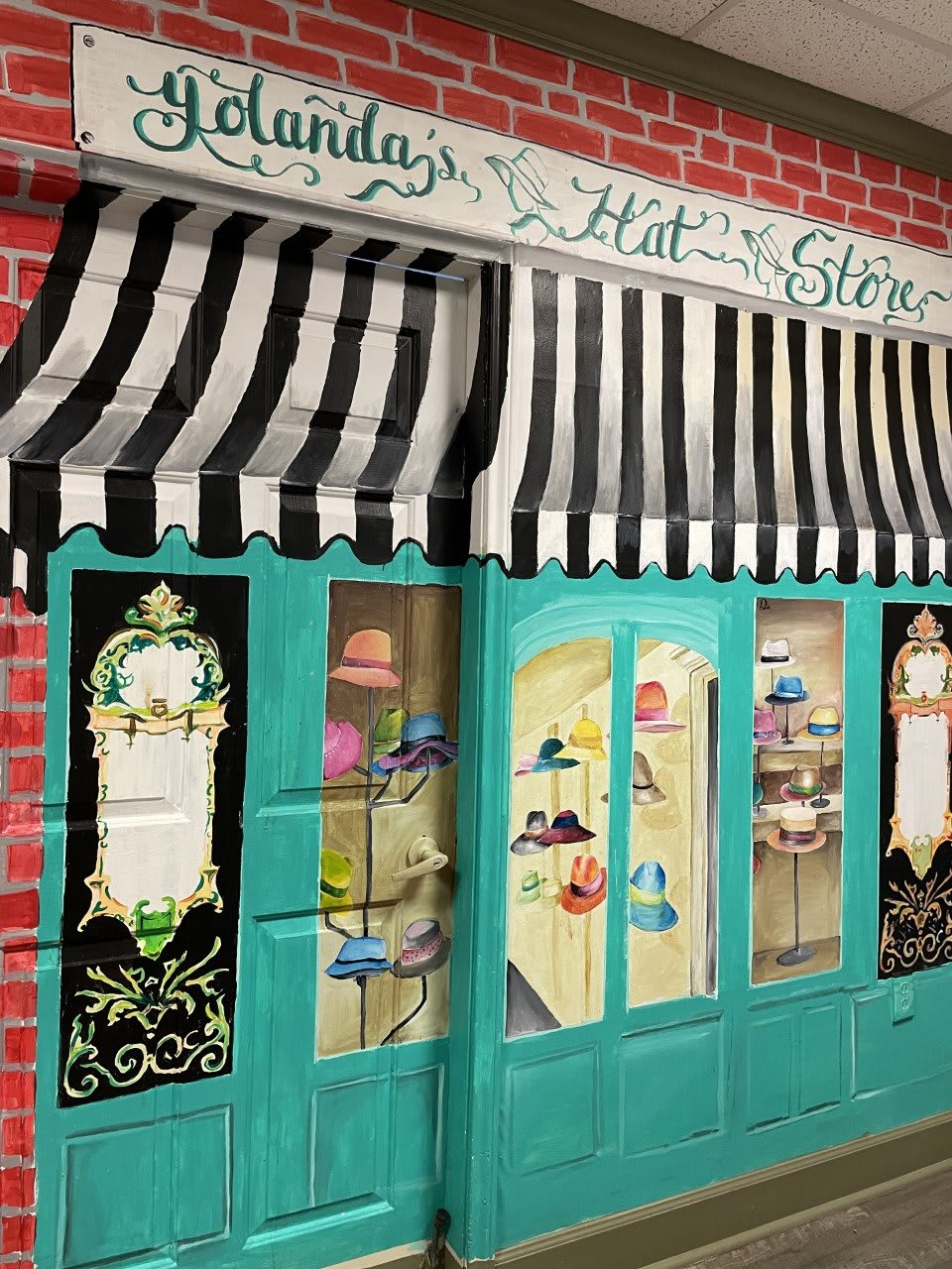 A charming hat store with a turquoise facade and striped awning displays an array of colorful hats in its windows.