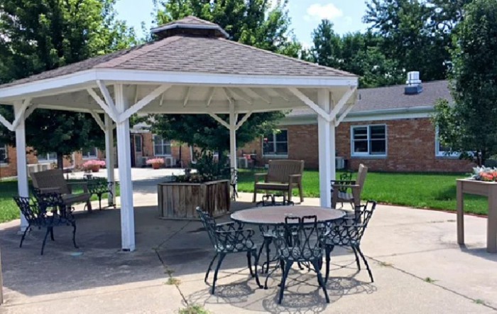 An outdoor patio area with a gazebo and furniture.