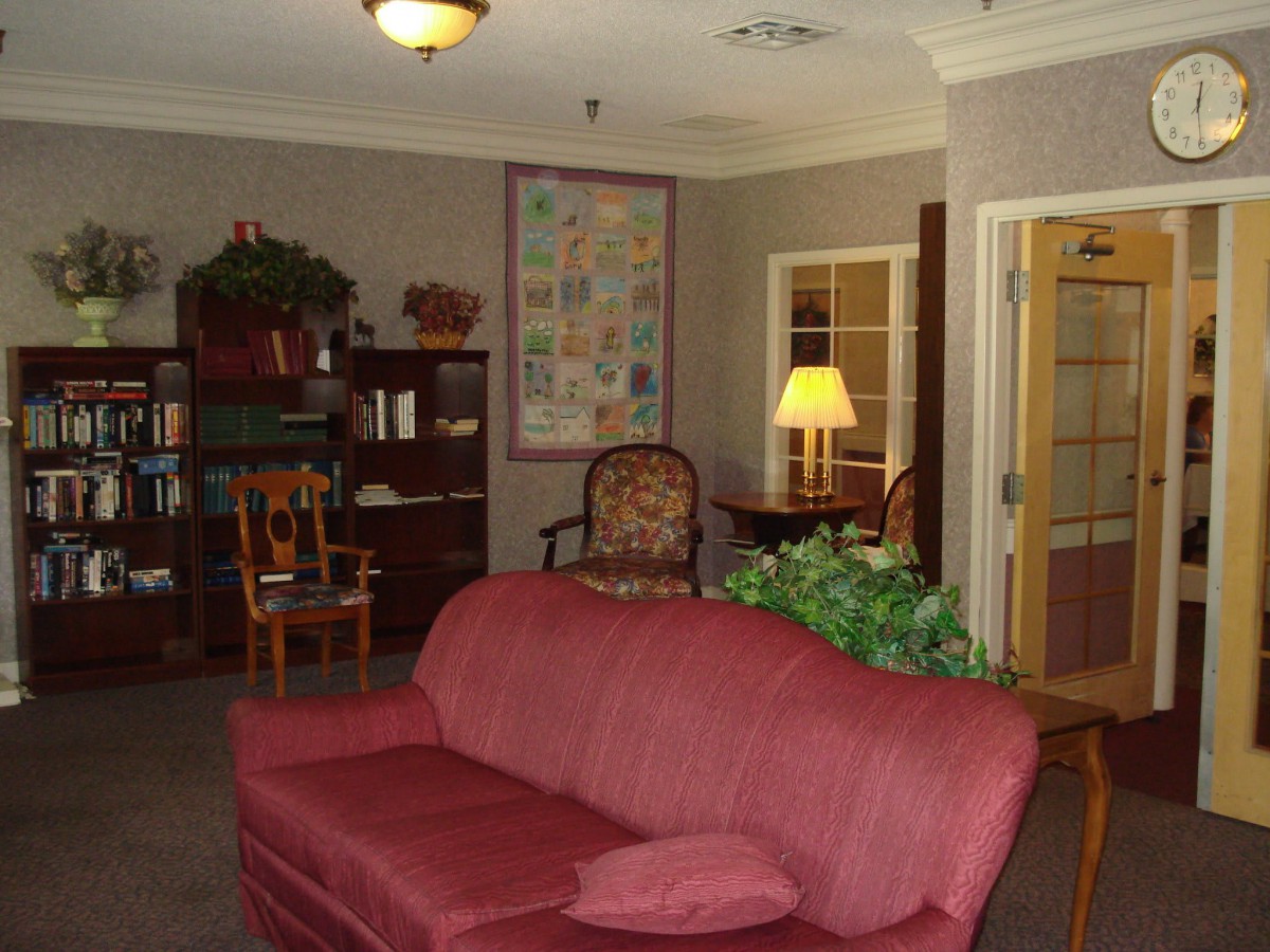 Cozy living room with a red sofa and warm lighting.